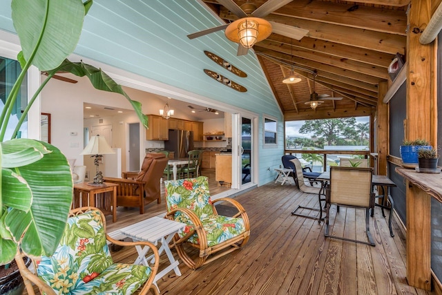 sunroom with ceiling fan and lofted ceiling