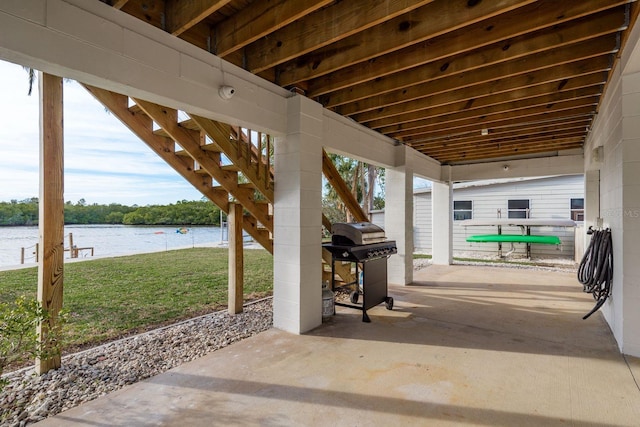 view of patio featuring a water view and grilling area