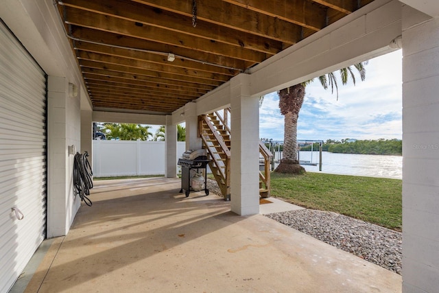 view of patio / terrace with a water view and a grill