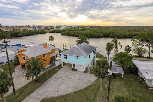 aerial view at dusk with a water view