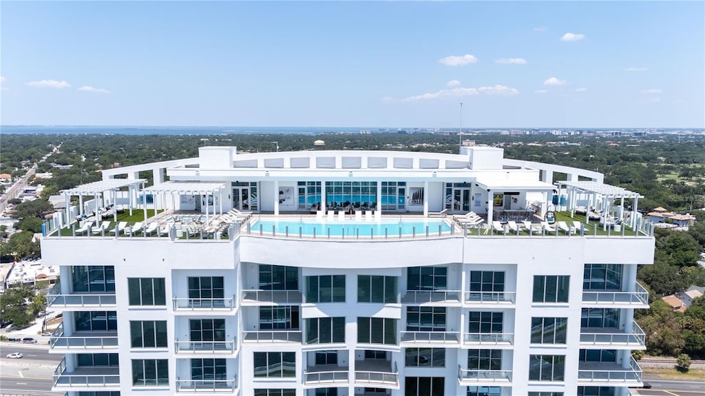 view of building exterior featuring a community pool