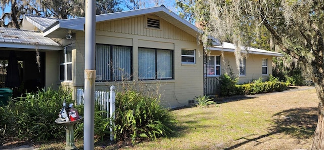 view of side of property with a lawn