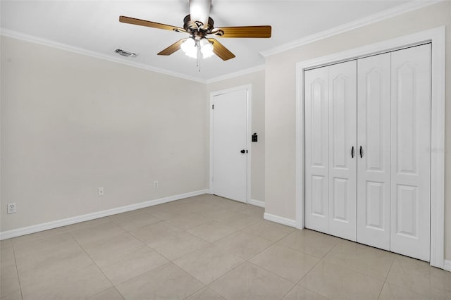 unfurnished bedroom featuring crown molding, light tile patterned floors, ceiling fan, and a closet