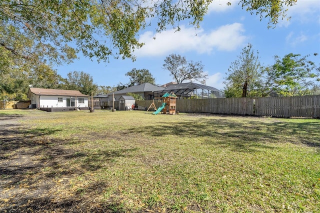 view of yard with an outdoor structure and a playground