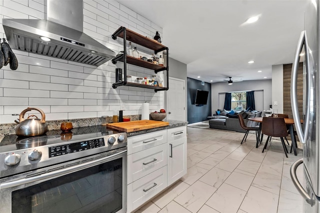 kitchen featuring appliances with stainless steel finishes, tasteful backsplash, island range hood, white cabinets, and ceiling fan