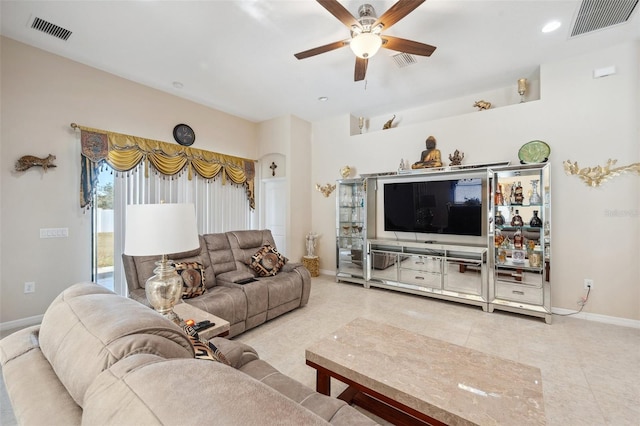 living room with ceiling fan and tile patterned floors