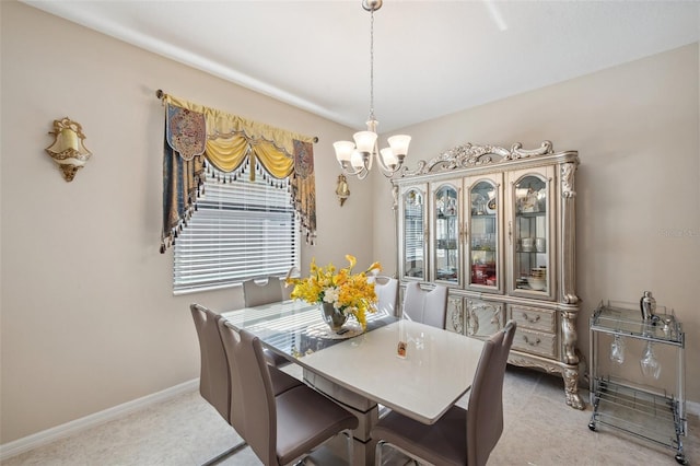 carpeted dining space featuring a notable chandelier