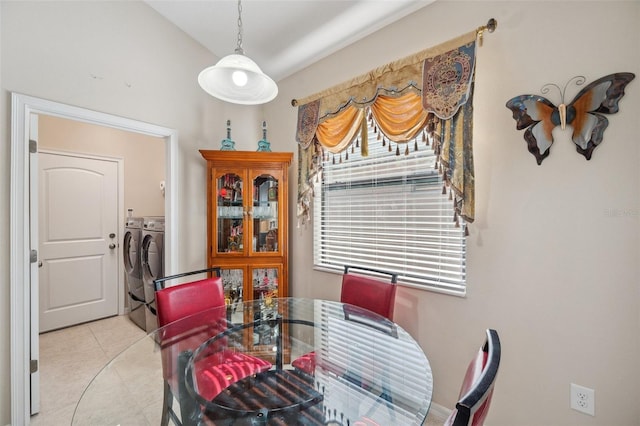 dining area with washing machine and dryer and light tile patterned floors