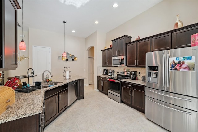 kitchen featuring pendant lighting, appliances with stainless steel finishes, and dark brown cabinetry