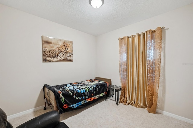 carpeted bedroom featuring a textured ceiling