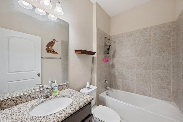 full bathroom featuring vanity, toilet, and tiled shower / bath combo