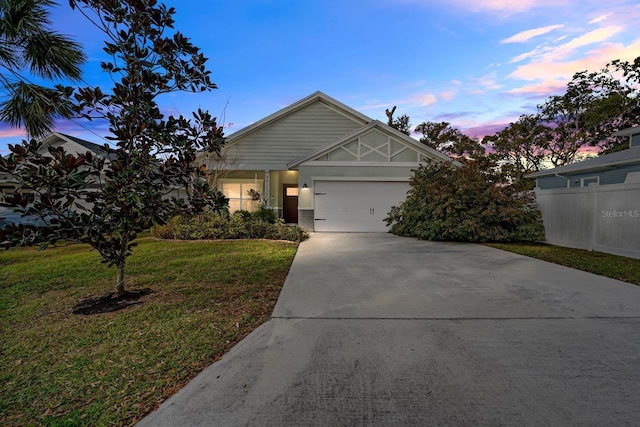 view of front facade with a yard and a garage