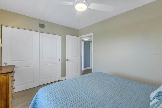 bedroom featuring ceiling fan, light hardwood / wood-style floors, and a closet