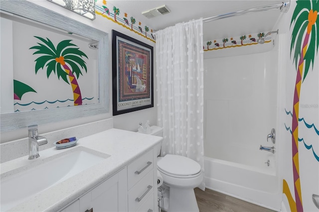 full bathroom featuring shower / bath combo, hardwood / wood-style floors, vanity, and toilet