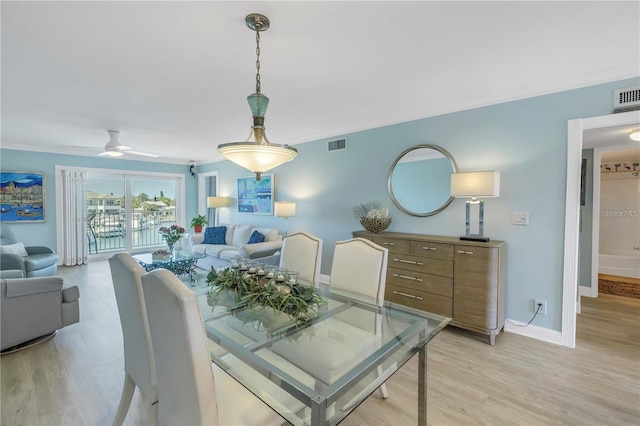 dining space with crown molding, ceiling fan, and light hardwood / wood-style flooring