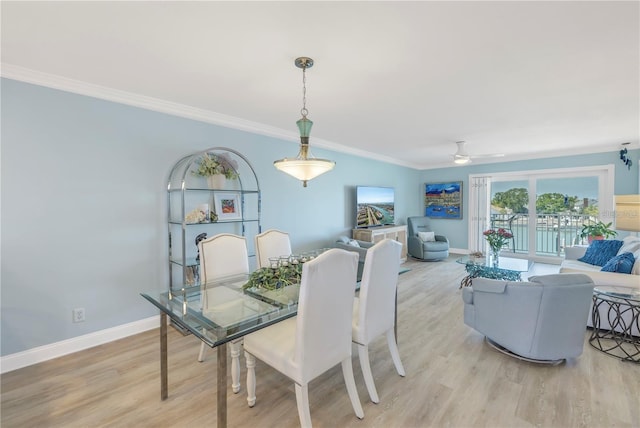 dining room featuring crown molding, ceiling fan, and light wood-type flooring