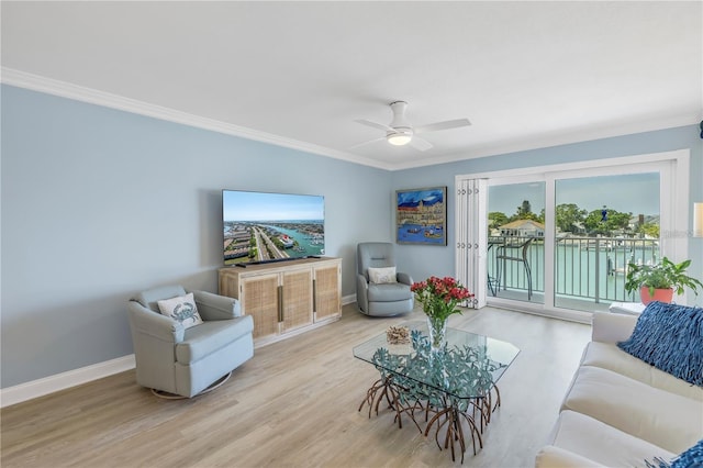 living room featuring crown molding, ceiling fan, and light hardwood / wood-style flooring