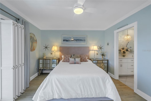 bedroom featuring crown molding, ensuite bath, ceiling fan, and light wood-type flooring