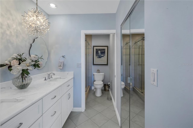 bathroom with walk in shower, vanity, tile patterned floors, and toilet