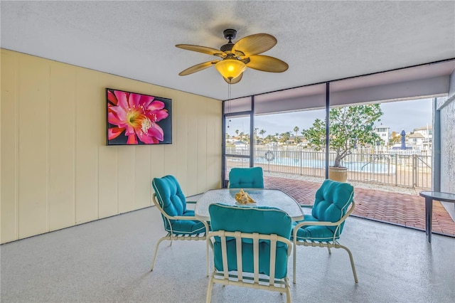 sunroom / solarium featuring ceiling fan