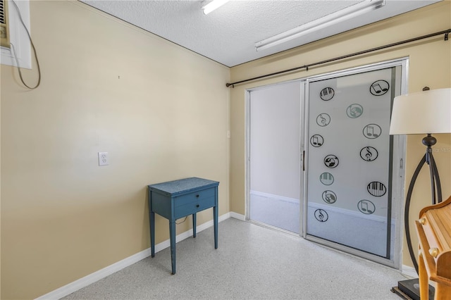 340 Pinellas Bayway S Unit 306, Tierra Verde, FL 33715 - interior space featuring a textured ceiling and a wall mounted air conditioner