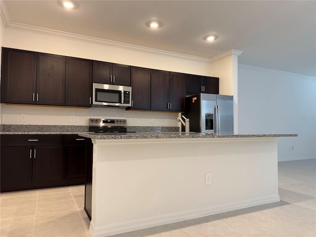 kitchen featuring ornamental molding, stainless steel appliances, a kitchen island with sink, and dark brown cabinets