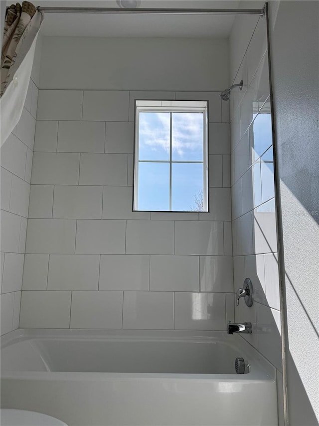 bathroom with toilet and shower / tub combo