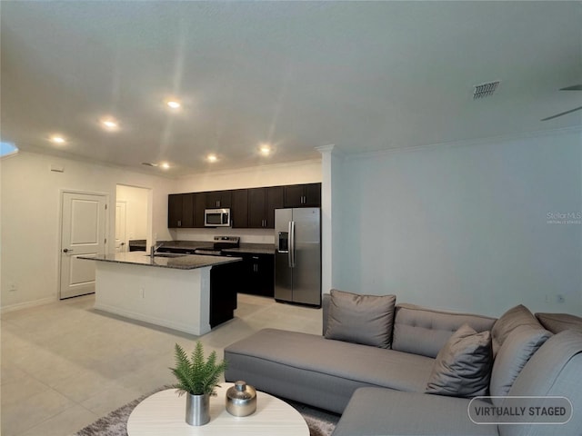 living room featuring crown molding, sink, and light tile patterned floors