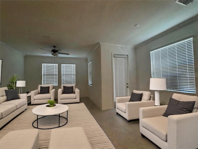 living room featuring tile patterned flooring, crown molding, and ceiling fan