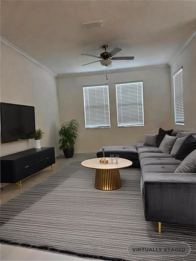 living room featuring ornamental molding and ceiling fan