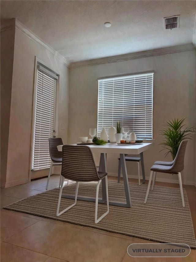 tiled dining area with ornamental molding