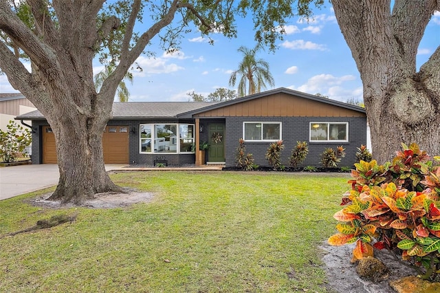 ranch-style house featuring a garage and a front lawn