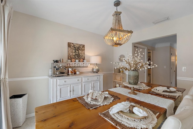 dining area featuring an inviting chandelier