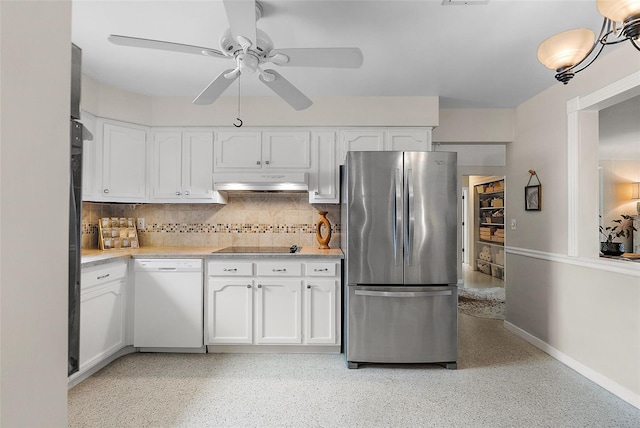 kitchen with stainless steel refrigerator, ceiling fan, white dishwasher, tasteful backsplash, and white cabinets