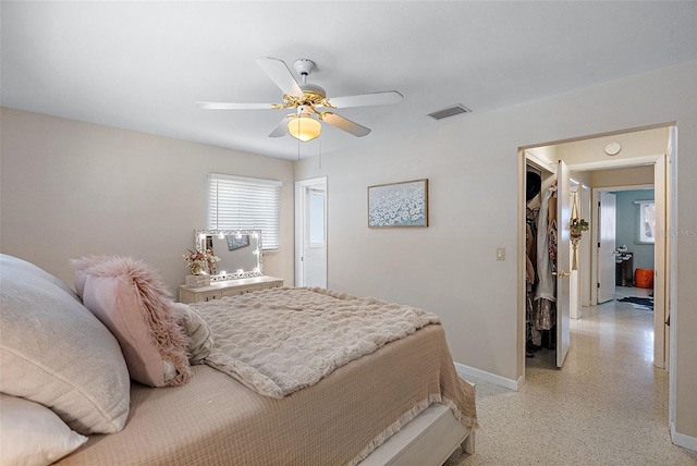 bedroom with ceiling fan and a closet