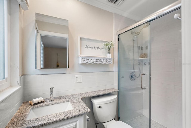 bathroom featuring tile walls, vanity, ornamental molding, an enclosed shower, and toilet