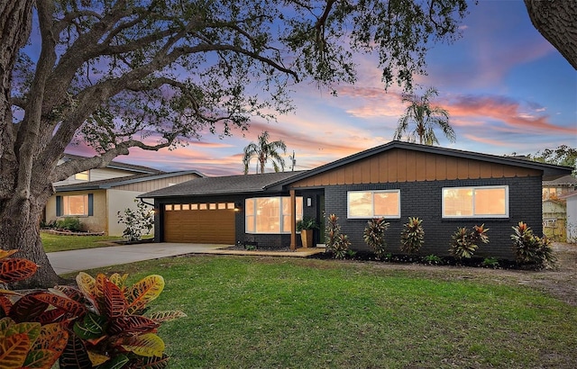 view of front of house with a garage and a yard