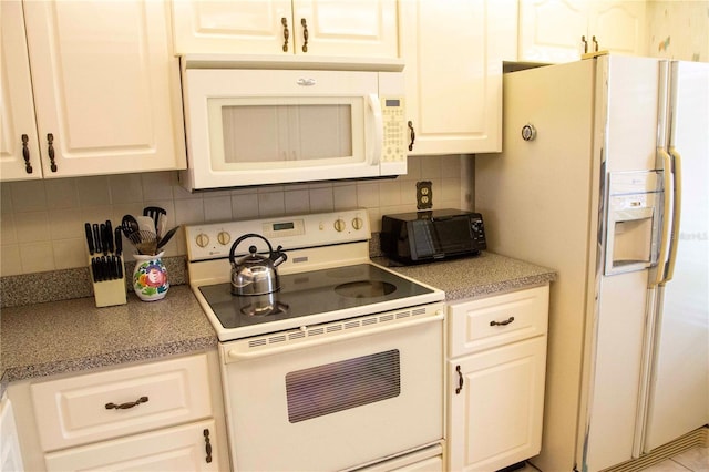 kitchen with tasteful backsplash, white cabinetry, and white appliances