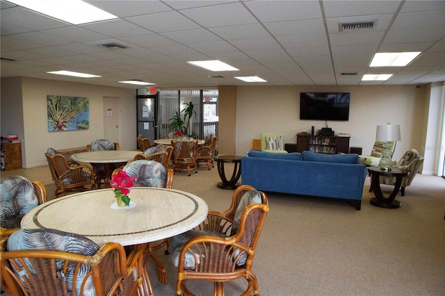 carpeted dining room featuring a paneled ceiling and visible vents