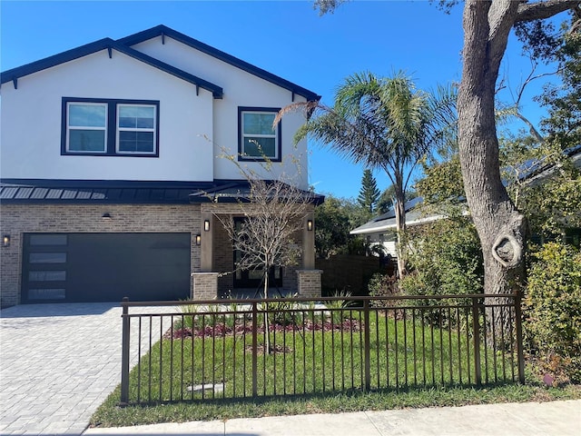 view of front of home featuring a garage and a front yard