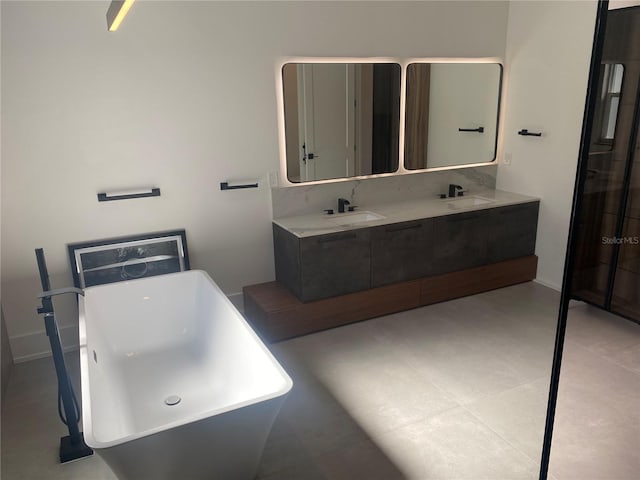 bathroom featuring vanity and a bath