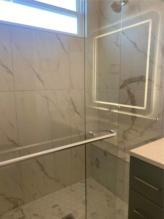 bathroom featuring a shower with shower door