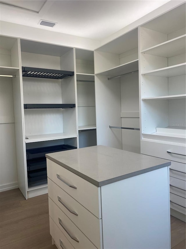 walk in closet featuring dark hardwood / wood-style flooring