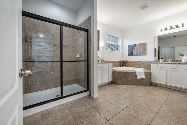 bathroom featuring vanity, tile patterned floors, and plus walk in shower