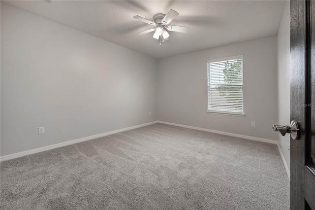 unfurnished room with a textured ceiling, ceiling fan, and carpet