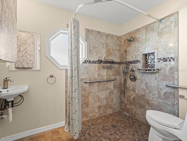 bathroom featuring toilet, tile patterned floors, sink, a textured ceiling, and a shower with shower curtain