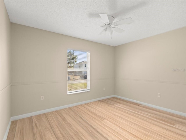 unfurnished room featuring ceiling fan, a textured ceiling, and light wood-type flooring