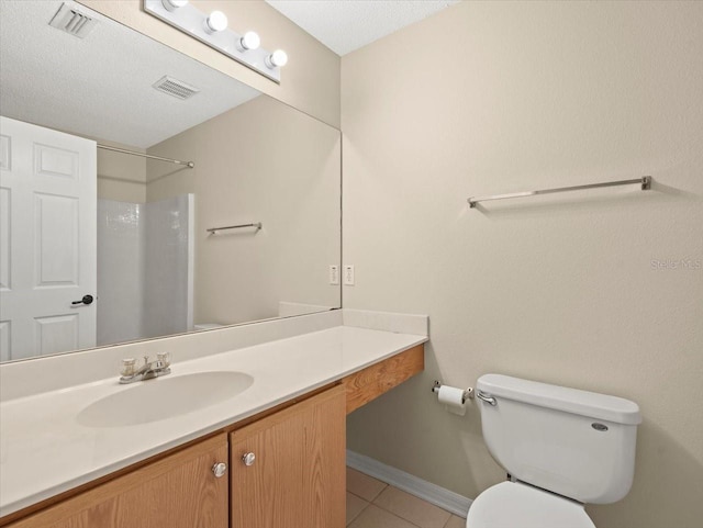 bathroom with toilet, vanity, tile patterned floors, a shower, and a textured ceiling