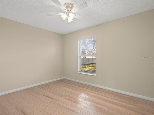 spare room featuring ceiling fan, a textured ceiling, and light wood-type flooring