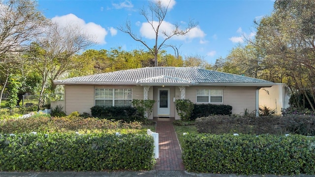 ranch-style home with a tile roof